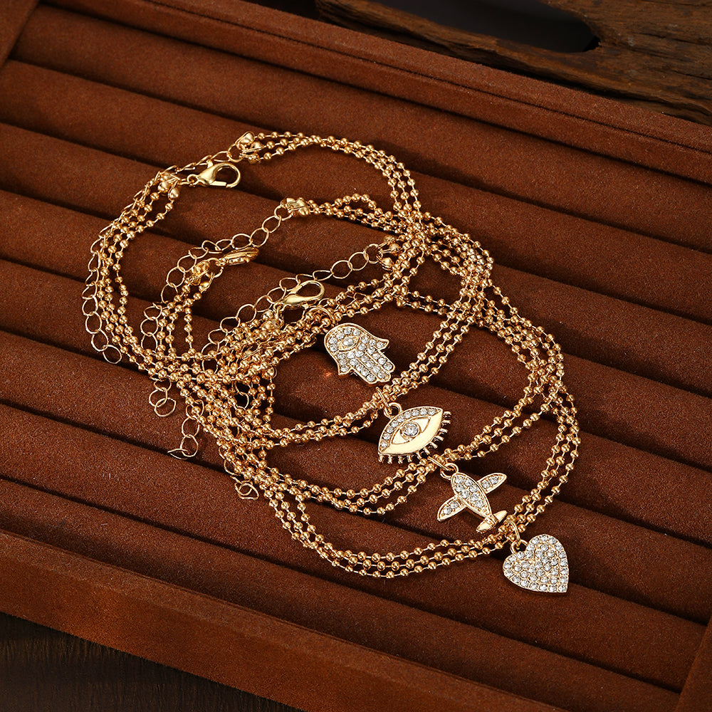Conjunto de pulseras con dijes chapadas en oro – Colección Elegancia y Protección