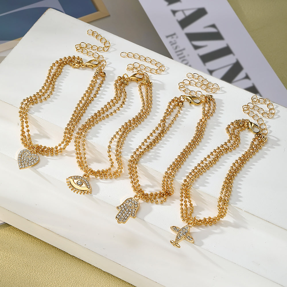 Conjunto de pulseras con dijes chapadas en oro – Colección Elegancia y Protección
